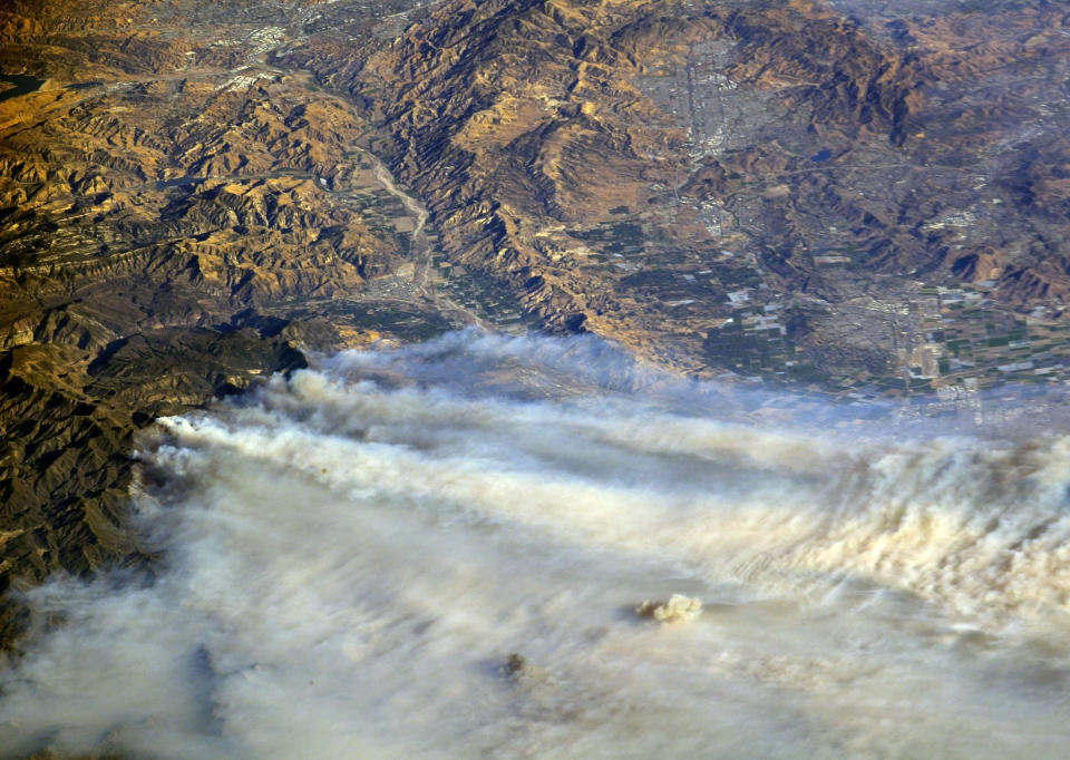 <p>A photo taken from the International Space Station and moved on social media by astronaut Randy Bresnik shows smoke rising from wildfire burning in Southern California, (Photo: @AstroKomrade/NASA/Handout via Reuters) </p>