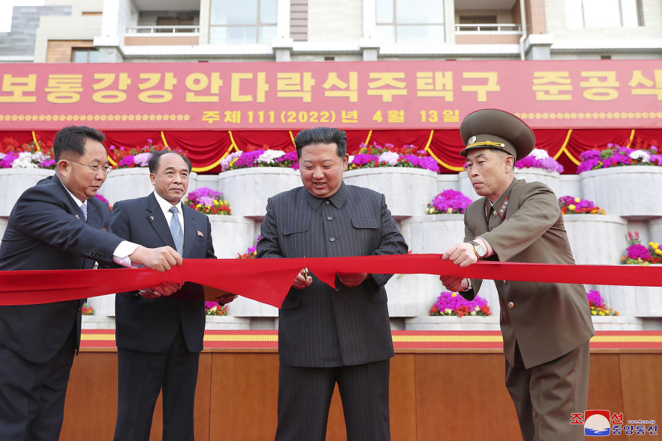 In this photo provided by the North Korean government, Kim Jong Un, second right, cuts the ribbon during an inauguration ceremony of Pothong riverside terraced residential district in Pyongyang, North Korea Wednesday, April 13, 2022. Independent journalists were not given access to cover the event depicted in this image distributed by the North Korean government. The content of this image is as provided and cannot be independently verified. Korean language watermark on image as provided by source reads: "KCNA" which is the abbreviation for Korean Central News Agency. (Korean Central News Agency/Korea News Service via AP)