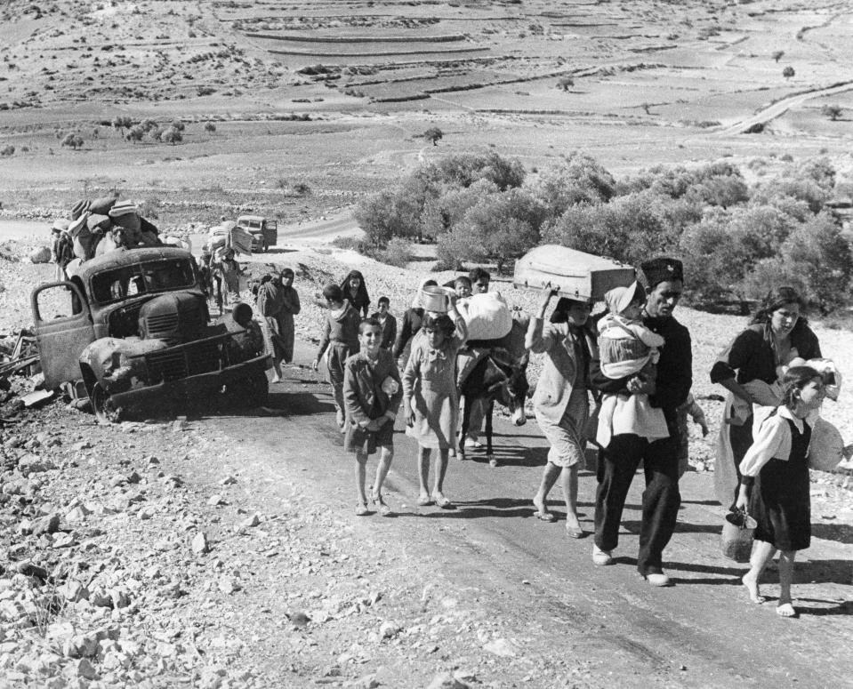 FILE - Arab villagers who fled from their homes during fighting between Israeli and Arab troops, on Nov. 4, 1948. (AP Photo/Jim Pringle, File)