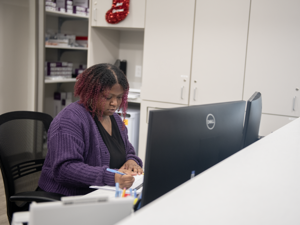 Destiny Johnson, a radiology technologist, works in an open desk area at the new UH Urgent Care Kent.
