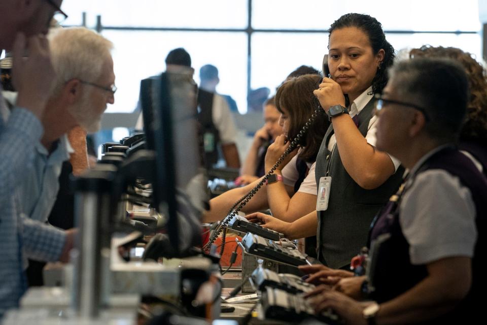 Delta Air Lines ticket agents (right) assist passengers in Terminal 3, July 19, 2024, at Phoenix Sky Harbor International Airport.