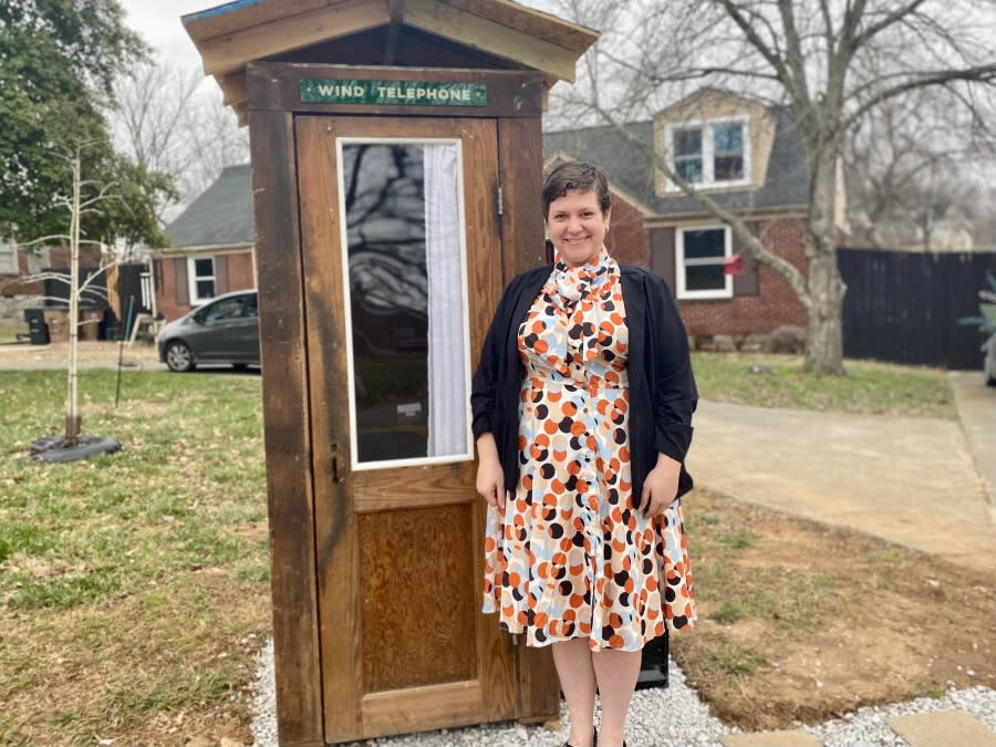 Allison Young, a cancer research nurse at Vanderbilt, stands beside the wind telephone she created to help people grieve their deceased loved ones. (WKRN)