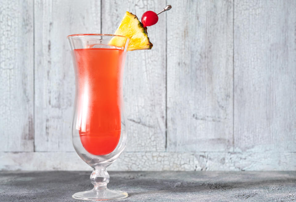 Glass of Singapore Sling on wooden background