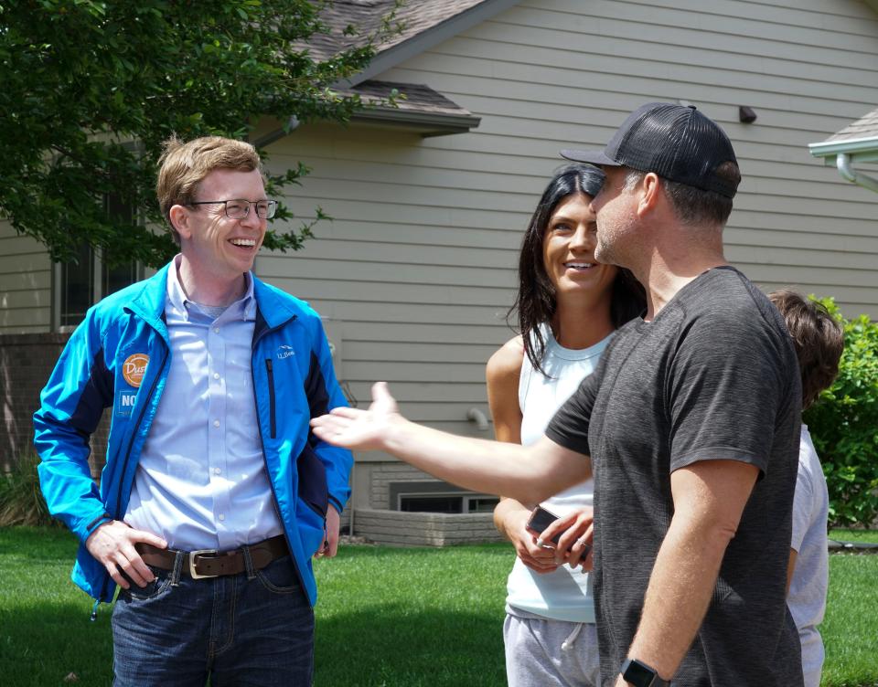 U.S. Representative Dusty Johnson speaks with people in southern Sioux Falls while door knocking with Gov. Kristi Noem on Saturday, June 4.