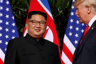 <p>President Donald Trump and North Korea leader Kim Jong Un stop to talk with the media as they walk from their lunch at the Capella resort on Sentosa Island Tuesday, June 12, 2018 in Singapore. (Photo: Evan Vucci/AP) </p>