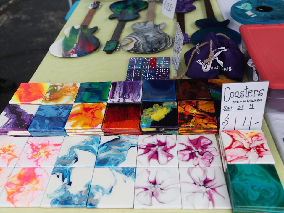 Pam Nicodemus' artistic coaster and decorative guitars at her booth Pam's Pours at the Farmer's Market at Tallmadge Recreation Center on Thursday.
