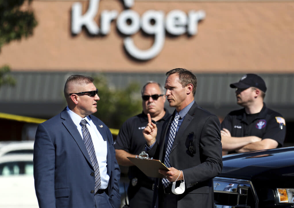 Law enforcement officers confer at the scene following a shooting at a Kroger’s grocery store in Collierville, Tenn., on Thursday, Sept. 23, 2021. (Patrick Lantrip/Daily Memphian via AP)