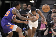 San Antonio Spurs' Blake Wesley, right, and Phoenix Suns' Saben Lee chase the ball during the first half of an NBA basketball game, Saturday, Jan. 28, 2023, in San Antonio. (AP Photo/Darren Abate)