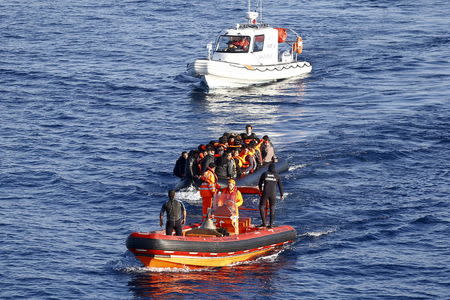 A Turkish Coast Guard fast rigid-hulled inflatable boat tows a dinghy filled with refugees and migrants in the Turkish territorial waters of the North Aegean Sea, following a failed attempt at crossing to the Greek island of Chios, off the shores of Izmir, Turkey, in this February 28, 2016 file photo. TURKEY REUTERS/Umit Bektas