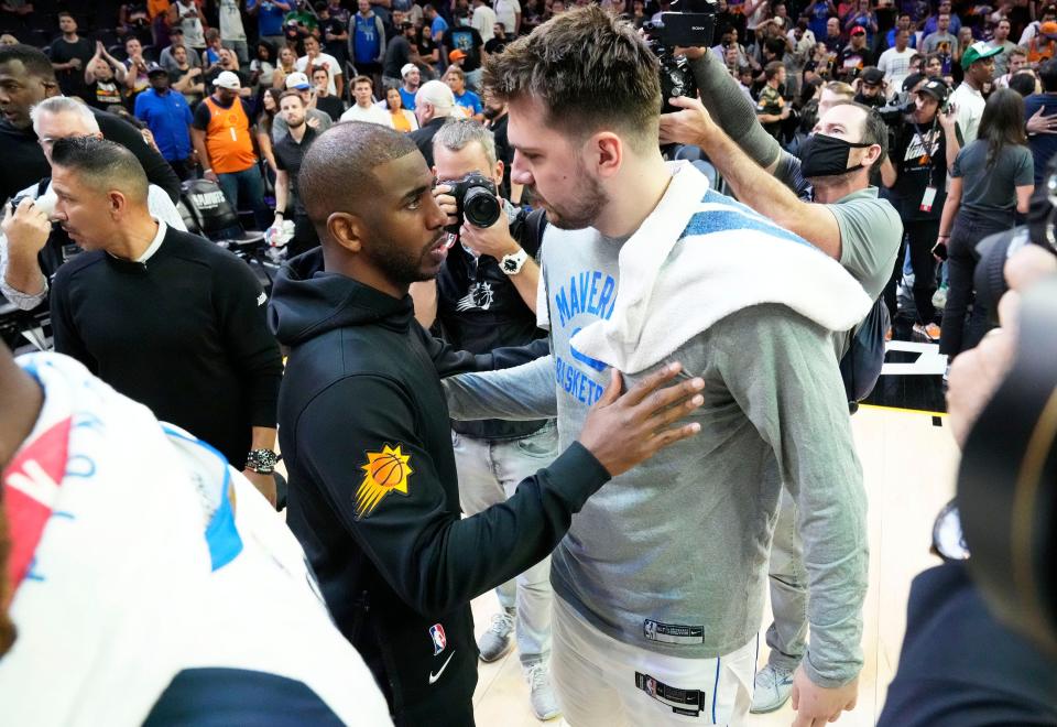 May 15, 2022; Phoenix, Arizona, USA; Phoenix Suns guard Chris Paul (3) congratulates Dallas Mavericks guard Luka Doncic (77) on his victory during game seven of the second round for the 2022 NBA playoffs at Footprint Center.