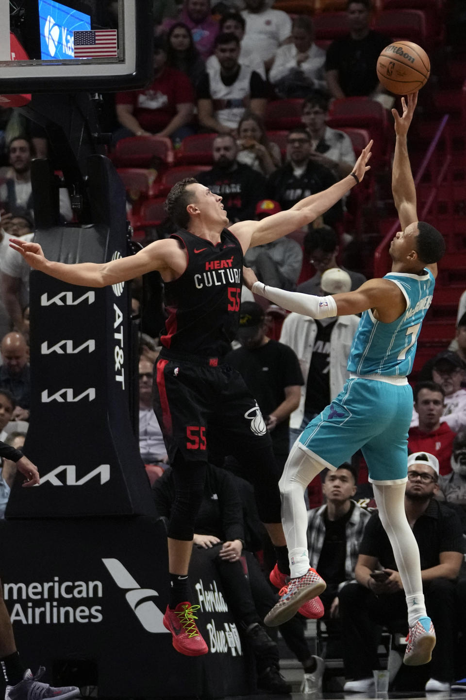 Charlotte Hornets guard Bryce McGowens (7) shoots over Miami Heat forward Duncan Robinson during the first half of an NBA basketball game, Wednesday, Dec. 13, 2023, in Miami. (AP Photo/Lynne Sladky)