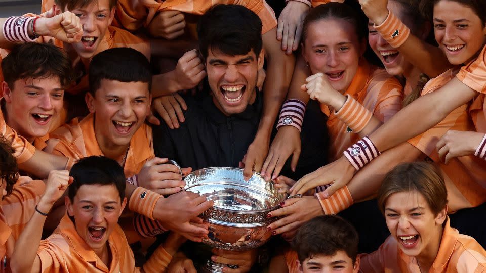Alcaraz celebrates with ball kids after winning the men's singles French Open final. - Lisi Niesner/Reuters