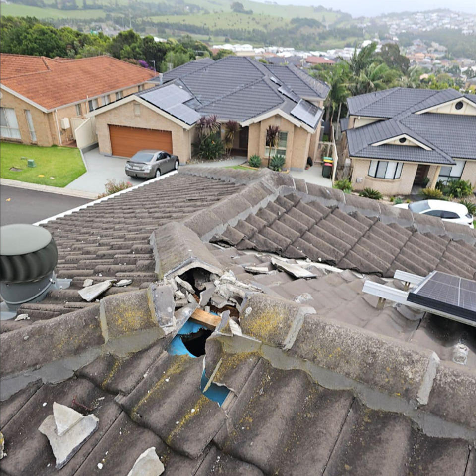 A hole is seen in the roof of the home, looking out across the suburb.