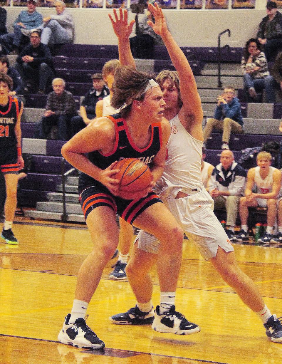 Pontiac's Logan Barnett looks to make a move to the basket against New Berlin Saturday. Barnett threw the inbound pass that led to Kerr Bauman's game-winning 3-pointer as the Indians posted a 43-40 victory.