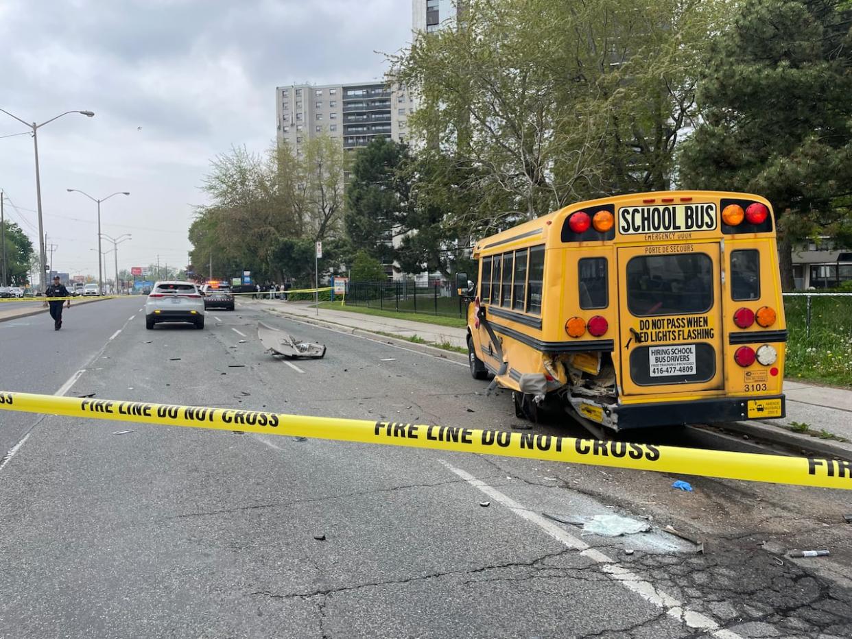 Toronto police say a man and a woman were rushed to hospital after a multi-vehicle collision that struck a parked school bus in Scarborough on Tuesday. (Oliver Walters/CBC - image credit)