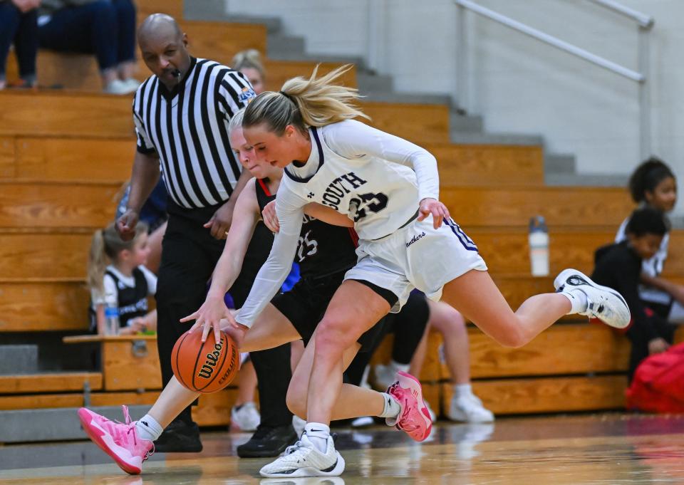 Bloomington South’s Abbie Lucas and Edgewood’s Ava Laroche chase after a loose ball during the game against Edgewood at Bloomington South on Tuesday, Nov. 7, 2023.