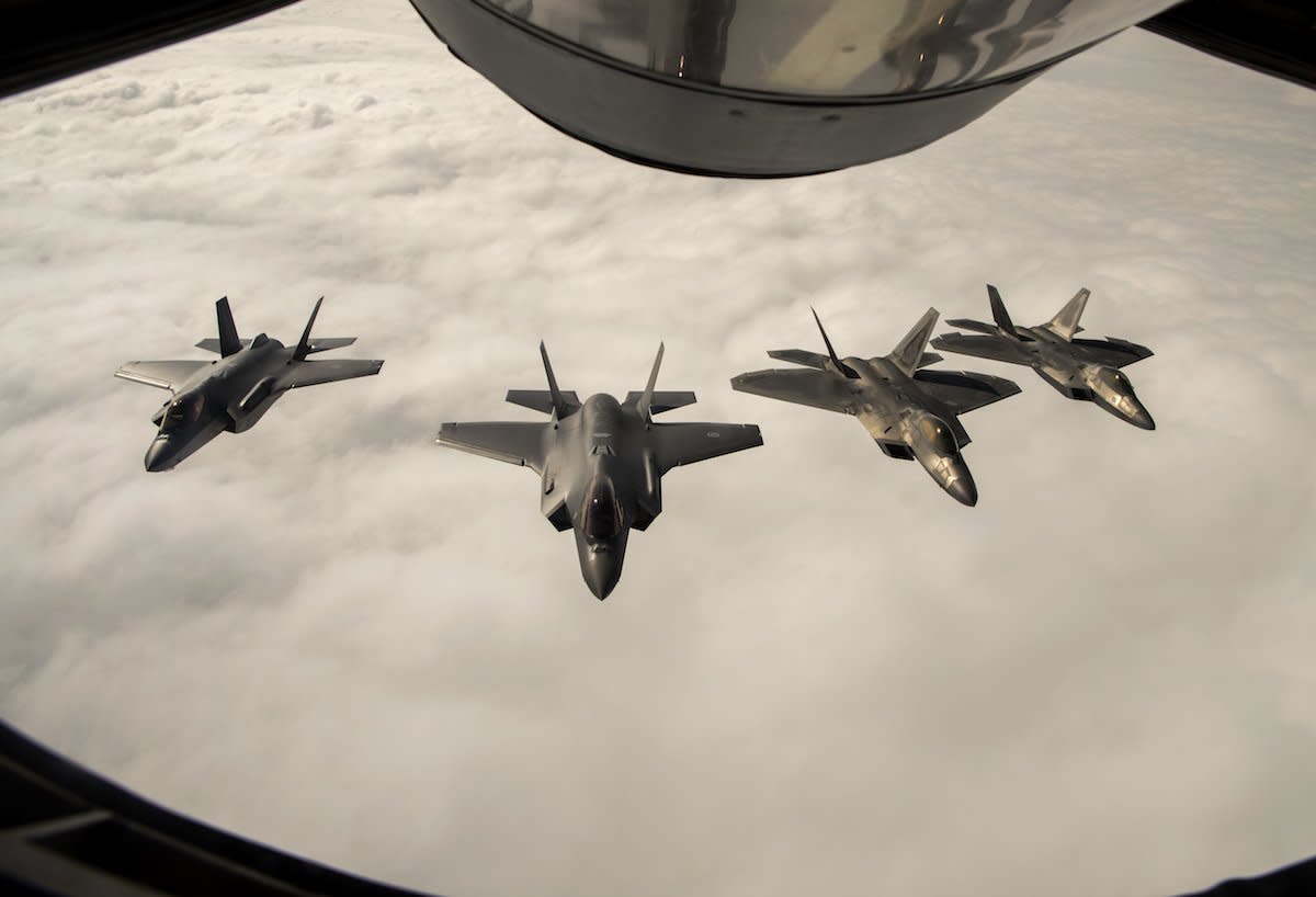 Two F-22 Raptors from the 95th Fighter Squadron, 325th Fighter Wing, Tyndall Air Force Base, Fla., fly in formation and conduct training operations with two Royal Norwegian air force F-35A Lightning II aircraft during an air refueling over Norway, Aug. 15, 2018.