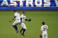 Houston Astros George Springer celebrates with Carlos Correa (1) after Game 4 of a baseball American League Championship Series against the Tampa Bay Rays, Wednesday, Oct. 14, 2020, in San Diego. The Astros defeated the Rays 4-3 and the Rays lead the series 3-1 games. (AP Photo/Gregory Bull)