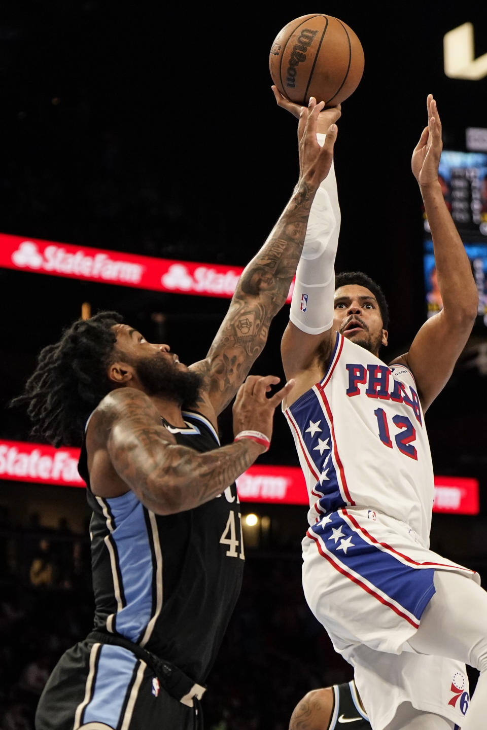 Philadelphia 76ers forward Tobias Harris (12) shoots against Atlanta Hawks forward Saddiq Bey (41) during the second half of an In-Season Tournament NBA basketball game, Friday, Nov. 17, 2023, in Atlanta. (AP Photo/Mike Stewart)