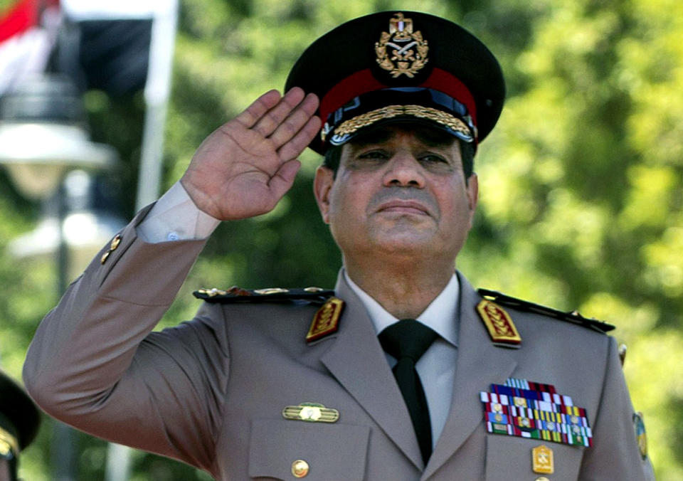 FILE - In this Wednesday, April 24, 2013 file photo, Egyptian Defense Minister Gen. Abdel-Fattah el-Sissi salutes during an arrival ceremony for U.S. Secretary of Defense Chuck Hagel at the Ministry of Defense in Cairo. Having secured victory in a referendum on a relatively liberal constitution that he championed, insiders say Egypt's military chief is turning his attention to the country’s overwhelming array of problems _ from health and education to government subsidies and investment. The revelations offer the latest indication that Gen. Abdel-Fattah el-Sissi is planning a run for president, capping a stunning transformation for the 59-year-old who started in the infantry.(AP Photo/Jim Watson, Pool, File)