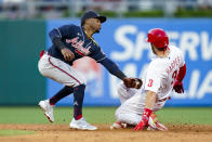 Philadelphia Phillies' Bryce Harper, right, avoids a tag by Atlanta Braves second baseman Ozzie Albies, left, during the third inning of a baseball game, Friday, July 23, 2021, in Philadelphia. (AP Photo/Chris Szagola)