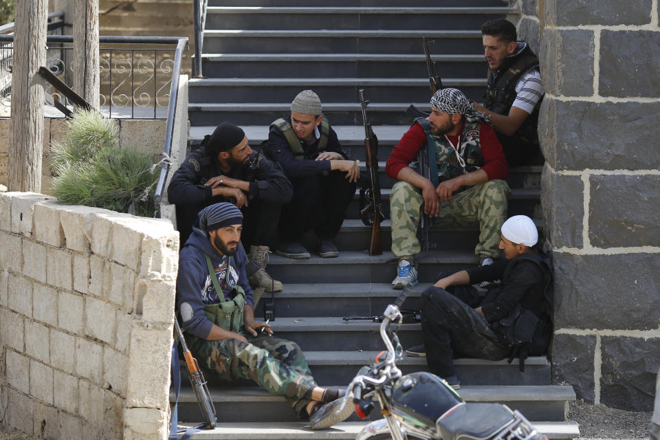 In this Thursday, Oct. 4, 2018, photo, young Druze armed men, rest after patrolling the village of Rami in the southern province of Sweida, Syria. Three months after a stunning Islamic State attack on a southeastern corner of Syria in which more than 200 people were killed and 30 women and children abducted, tensions are boiling over, and young men are taking up arms. It is a stark change for a province that managed to stay on the sidelines of the seven-year Syrian war and where most villagers worked grazing livestock over surrounding hills. (AP Photo/Hassan Ammar)