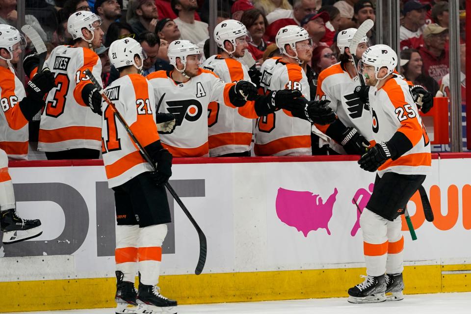 Philadelphia Flyers left wing James van Riemsdyk (25) is congratulated for his first-period goal in the team's NHL hockey game Washington Capitals, Tuesday, April 12, 2022, in Washington. (AP Photo/Alex Brandon)