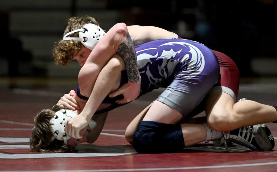 State College’s Nick Berrena wrestles Mifflin County’s Blake Aumiller in the127 lb bout of the match on Thursday, Jan. 25, 2024.
