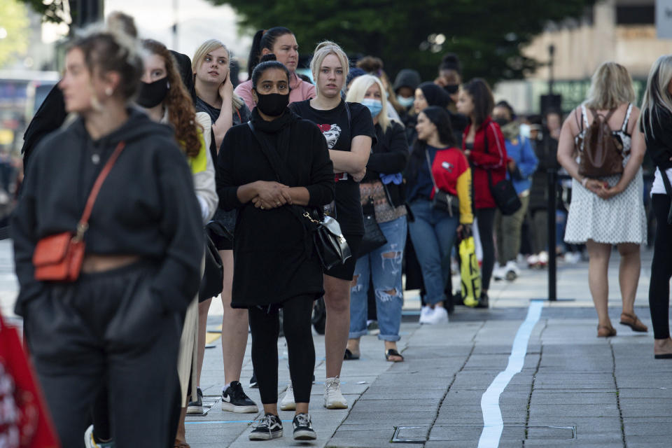 Shoppers queue outside Primark in Birmingham on Monday.