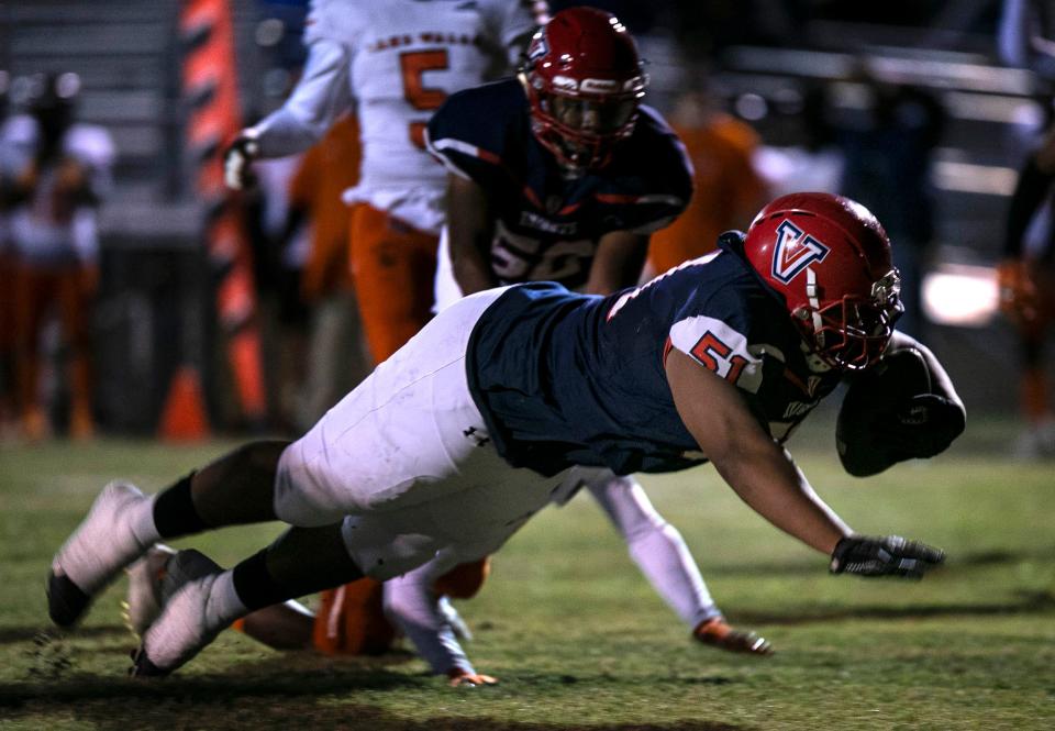 Vanguard’s Dejon McBride (51) stretches into the end zone for the touchdown in first half action against Lake Wales. The Knights won 24-13 at Booster Stadium, Friday, November 18, 2021, in Ocala, Florida.  [Cyndi Chambers/For the Star Banner] 2021