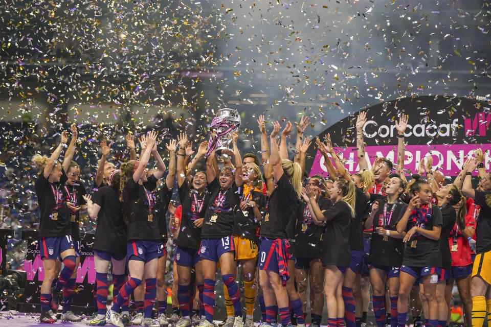 United States' players hold the trophy as they celebrate winning the CONCACAF Women's Championship final soccer match against Canada in Monterrey, Mexico, Monday, July 18, 2022. (AP Photo/Fernando Llano)