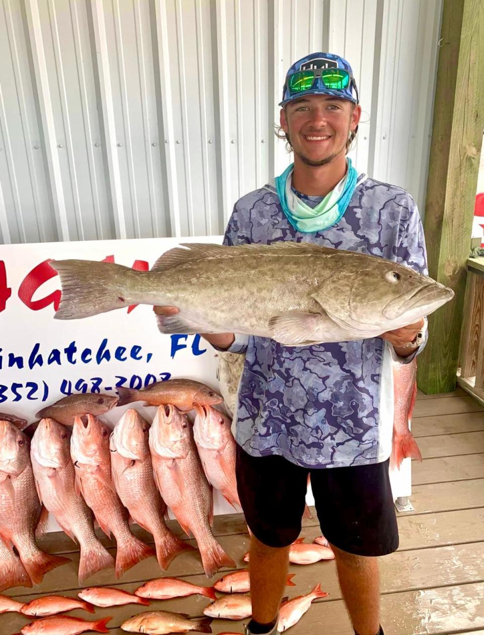 Wyatt Underwood holds up a monster gag grouper caught while fishing with Capt. Eli & Jadon Bray.