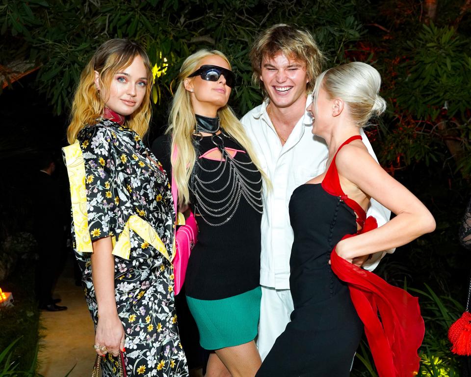 Paris Hilton, Jordan Barrett and Caroline Vreeland, and a guest.