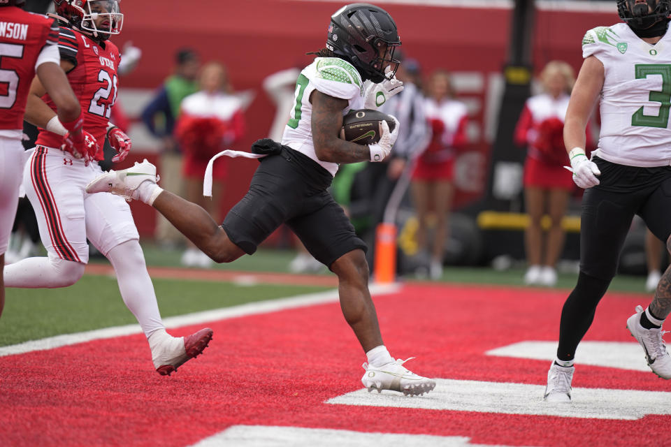 Oregon running back Bucky Irving (0) scores against Utah during the first half of an NCAA college football game Saturday, Oct. 28, 2023, in Salt Lake City. (AP Photo/Rick Bowmer)