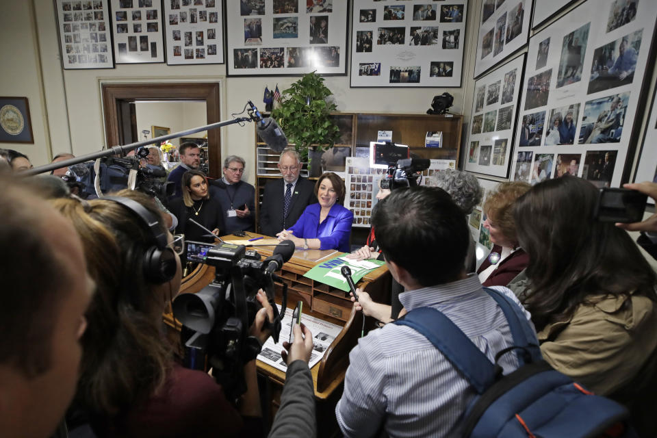 FILE - In this Wednesday, Nov. 6, 2019, file photo, Democratic presidential candidate Sen. Amy Klobuchar, D-Minn., center, speaks to media after filing to be listed on the New Hampshire primary ballot at the Statehouse, in Concord, N.H. The quadrennial chaos has quieted down at the New Hampshire secretary of state’s office with the closing of the filing period for the first-in-the-nation presidential primary. (AP Photo/Elise Amendola, File)