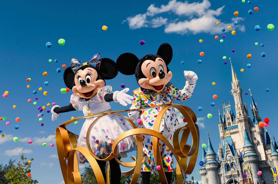 Mickey and Minnie Mouse at a parade in Disney World's Magic Kingdom.