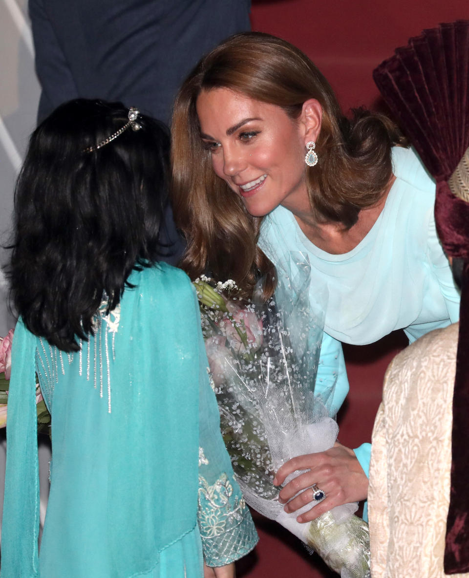 The Duchess also accessorised with statement teal earrings. [Photo: Getty]