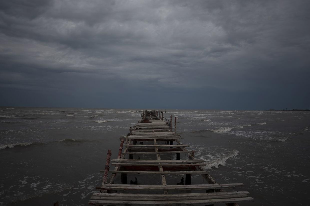 Waves kick up under a dark sky along the shore of Batabano, Cuba, Monday, Sept. 26, 2022. Hurricane Ian was growing stronger as it approached the western tip of Cuba on a track to hit the west coast of Florida as a major hurricane as early as Wednesday.