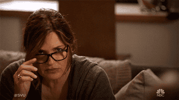 Olivia Benson taking off her glasses, looking confused as the words "dun dun" flash near her head.