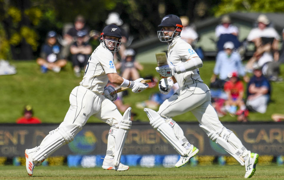 New Zealand batsmen Henry Nicholls, left, and Kane Williamson run between the wickets during play on day two of the second cricket test between Pakistan and New Zealand at Hagley Oval, Christchurch, New Zealand, Monday, Jan 4. 2021. (John Davidson/Photosport via AP)