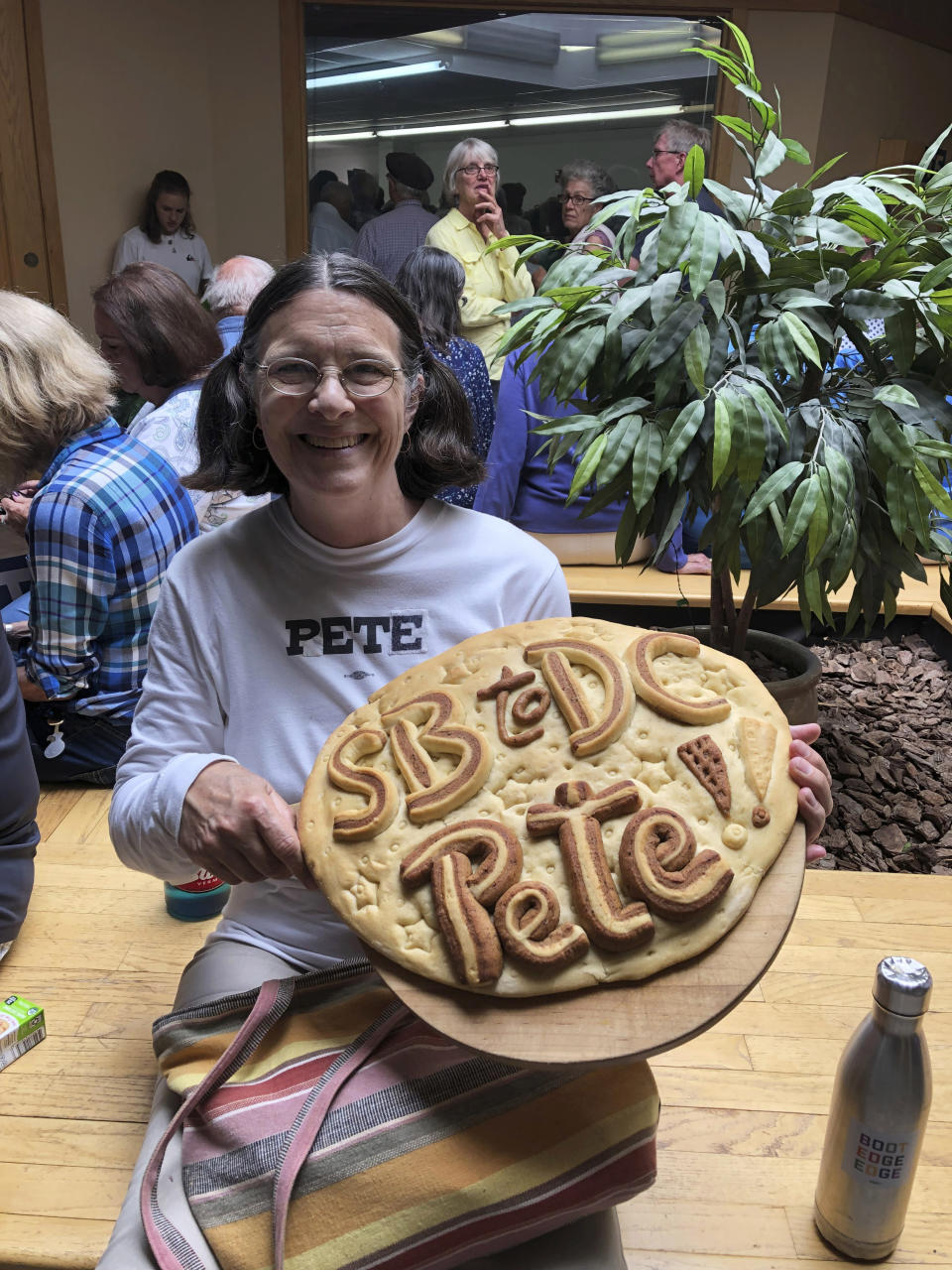 In this Friday, July 12, 2019, photo, Rhu McBee, 68, attends an event with South Bend, Ind., Mayor Pete Buttigieg in Laconia, N.H. McBee is wearing a t-shirt from Beto O’Rourke’s Texas Senate race but used tape to turn “Beto” into “Pete.” Former Vice President Joe Biden and South Bend Mayor Pete Buttigieg represent the generational poles of the crowded Democratic presidential primary. Biden is hoping Democratic voters see his decades of experience as the remedy for Trump’s presidency. Buttigieg argues that the moment calls for the energy of a new generation. (AP Photo/Julie Pace)