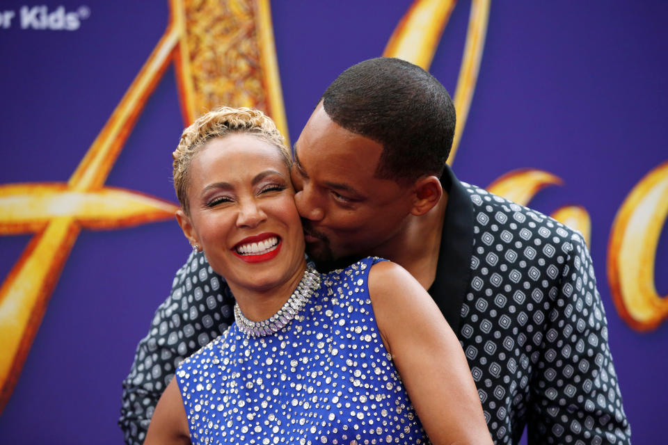 Cast member Will Smith kisses his wife Jada Pinkett Smith during the premiere of 