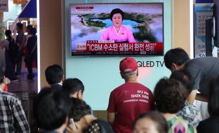 FILE PHOTO: People watch a TV news report about North Korea's hydrogen bomb test at a railway station in Seoul, South Korea on September 3, 2017. Han Jong-Chan/Yonhap/via REUTERS/File Photo