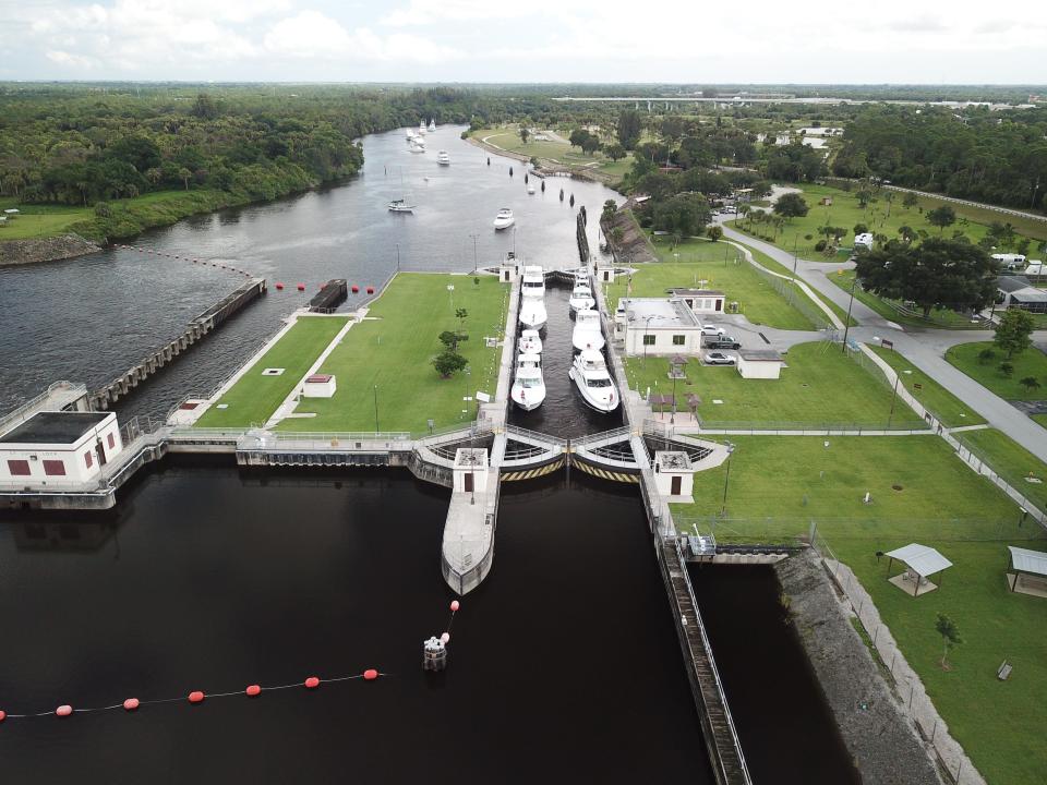 Seven boats transit the lock at St. Lucie Lock and Dam in western Martin County Thursday while nearly a dozen more await their turn in the south fork of the St. Lucie River. Boaters were moving vessels inland to protect them from Hurricane Dorian.