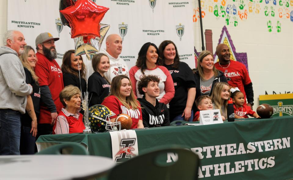 Northeastern senior Carson Terrell smiles with his family during his signing to play football at the University of Indianapolis Feb. 1, 2023.