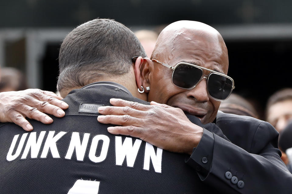 Freddy Cuevas, right, the companion of Evelyn Rodriguez, is consoled outside Saint Anne's Roman Catholic Church after her funeral, in Brentwood, N.Y., Friday, Sept. 21, 2018. Rodriguez, 50, is a mother recognized by President Donald Trump for turning grief over her daughter's suspected gang killing into a crusade against MS-13. She was struck and killed by an SUV on Sept. 14 after a heated confrontation with the driver over the placement of a memorial to her slain daughter, Kayla Cuevas. (AP Photo/Richard Drew)