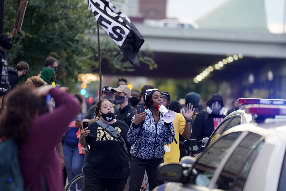 Black Lives Matter protesters march, Friday, Sept. 25, 2020, in Louisville. Breonna Taylor's family demanded Friday that Kentucky authorities release all body camera footage, police files and the transcripts of the grand jury hearings that led to no charges against police officers who killed the Black woman during a March drug raid at her apartment. (AP Photo/Darron Cummings)