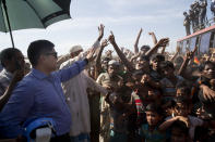 A Bangladeshi officer tries to calm Rohingya refugees during a protest against repatriation at Unchiprang refugee camp near Cox's Bazar, in Bangladesh, Thursday, Nov. 15, 2018. The head of Bangladesh's refugee commission said plans to begin a voluntary repatriation of Rohingya Muslim refugees to their native Myanmar on Thursday were scrapped after officials were unable to find anyone who wanted to return. (AP Photo/Dar Yasin)