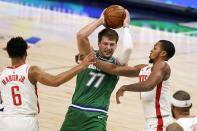 Houston Rockets forward Kenyon Martin Jr. (6) and guard Sterling Brown, right, defend against Dallas Mavericks' Luka Doncic (77) during the first half of an NBA basketball game in Dallas, Saturday, Jan. 23, 2021. (AP Photo/Tony Gutierrez)