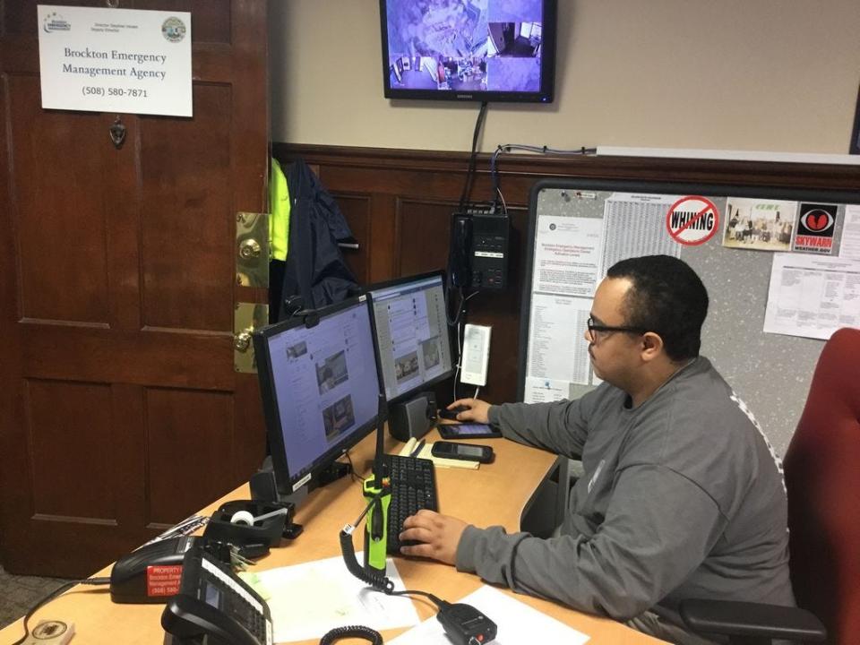 Anthony Fowler, operations coordinator for the Brockton Emergency Management Agency, mans the phone lines at BEMA headquarters in the Brockton War Memorial Building during the snowstorm on Tuesday, March 13, 2018.